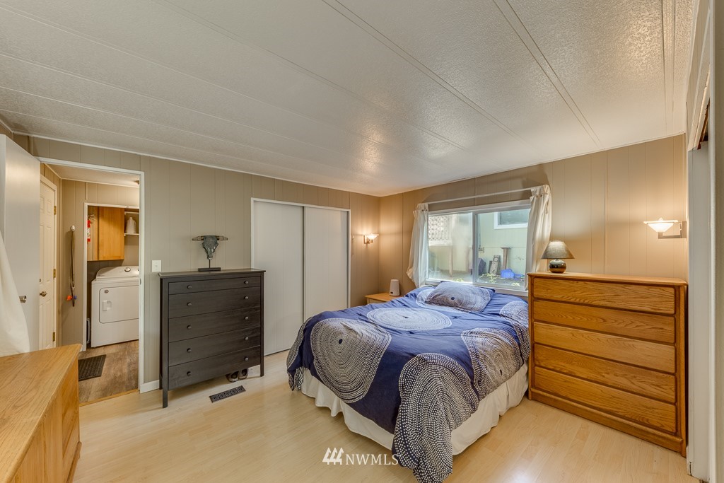 3318 206th Place Southeast Bothell, WA 98012 - Photo 13 of 35 a bedroom with a bed and a mirror