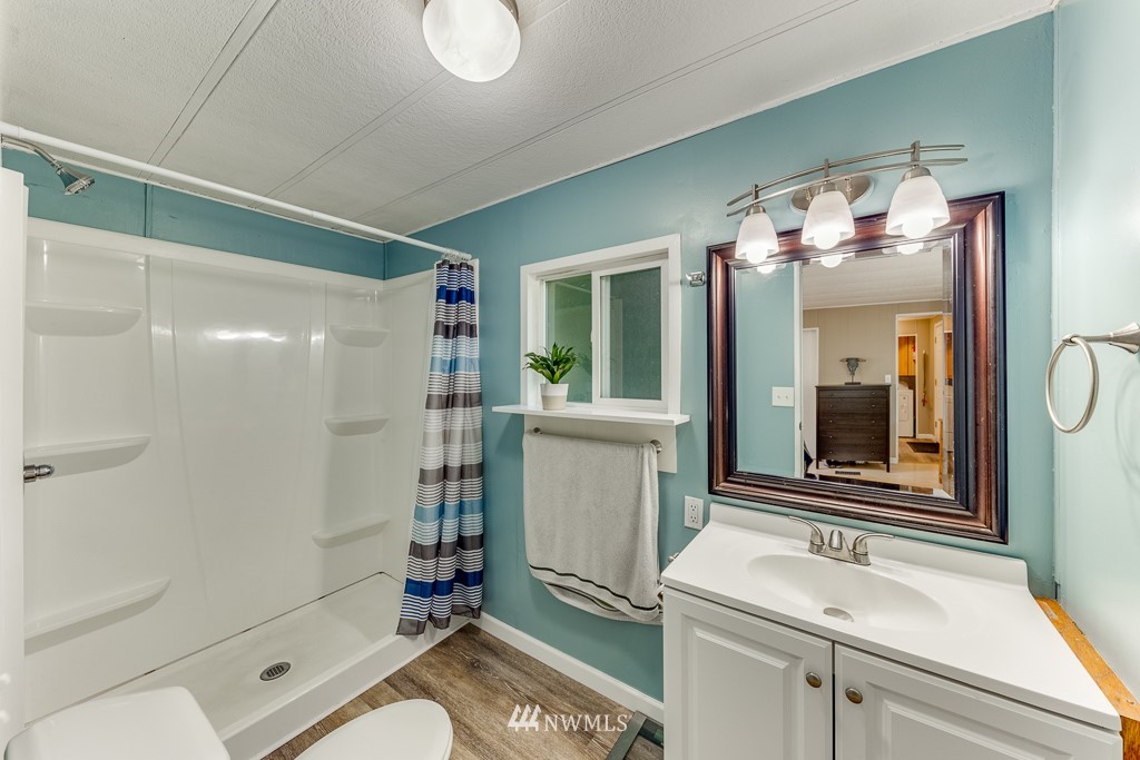 3318 206th Place Southeast Bothell, WA 98012 - Photo 14 of 35 a bathroom with a sink a toilet and shower