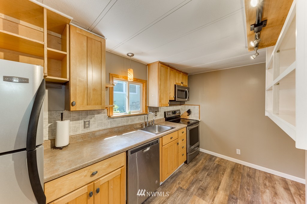 3318 206th Place Southeast Bothell, WA 98012 - Photo 17 of 35 a kitchen with a sink appliances and cabinets