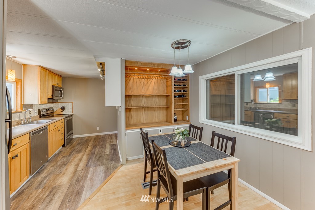 3318 206th Place Southeast Bothell, WA 98012 - Photo 19 of 35 a view of a dining room with furniture window and wooden floor