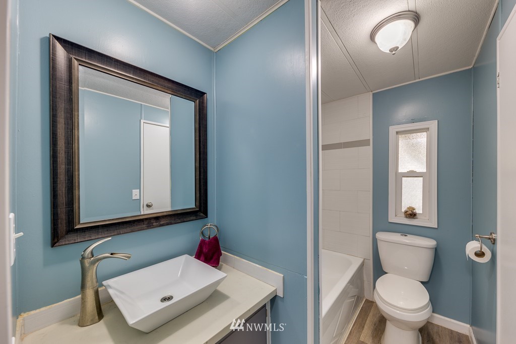 3318 206th Place Southeast Bothell, WA 98012 - Photo 23 of 35 a bathroom with a toilet sink and mirror