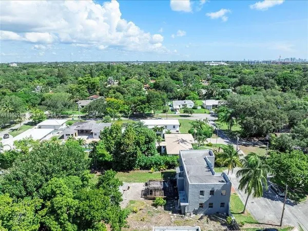 an aerial view of a house with a yard and lake view