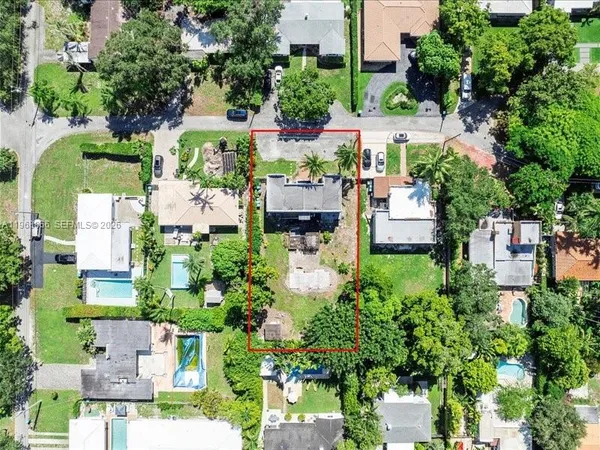 an aerial view of a residential houses with outdoor space and street view
