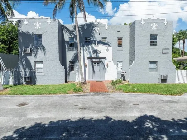 a front view of a house with a yard and a garage