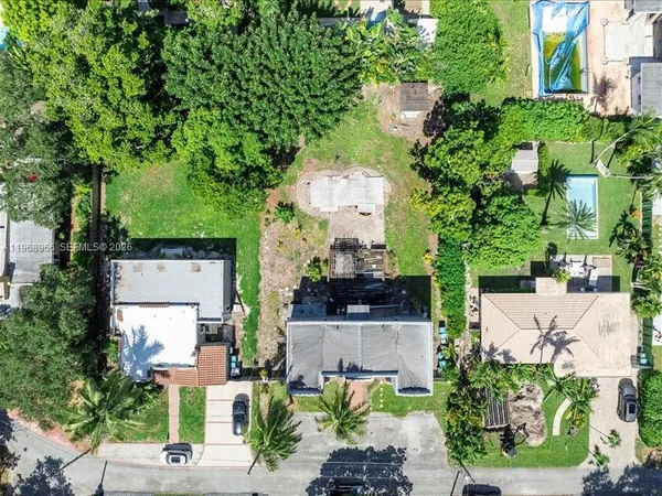 an aerial view of a house with a garden and trees