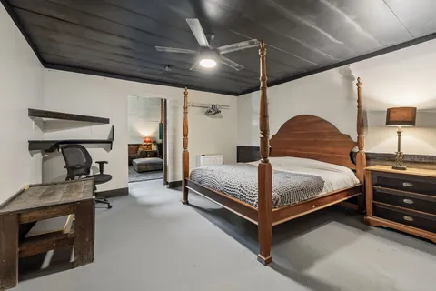 a bedroom with a bed and a chair