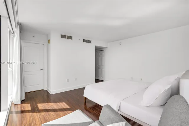 a bed room with a bed and a rug