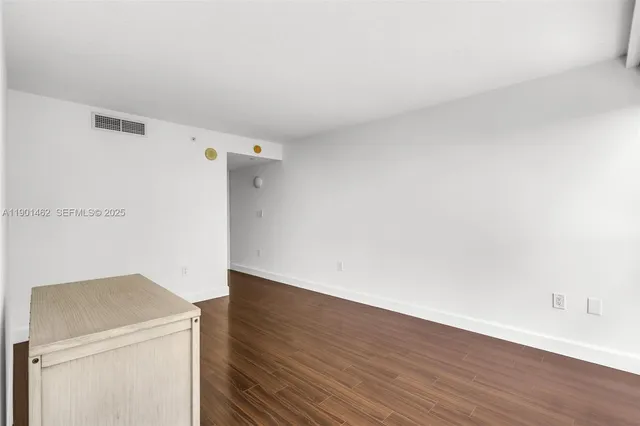 a view of a kitchen with wooden floor