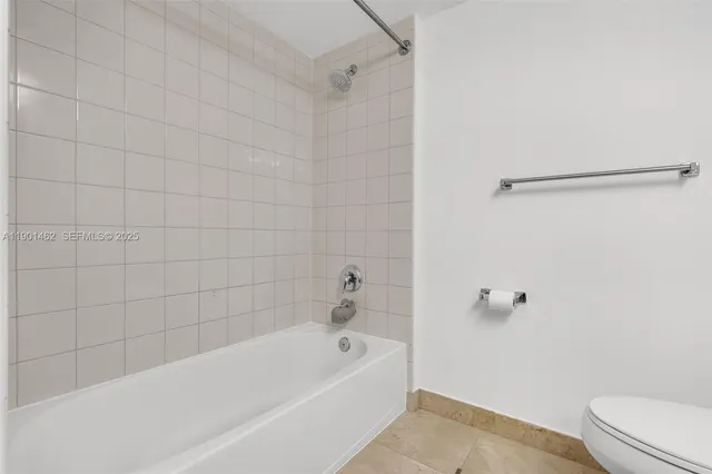 a bathroom with a bathtub and a toilet