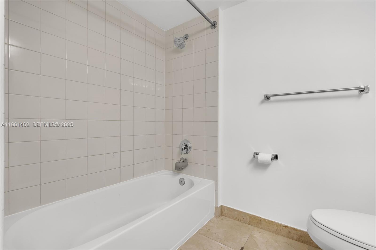 2101 Brickell Avenue, Unit 306 Miami, FL 33129 - Photo 22 of 49 a bathroom with a bathtub and a toilet