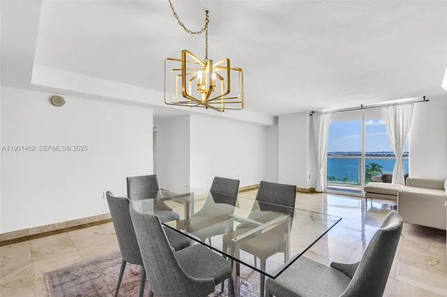 a living room with furniture and dining table