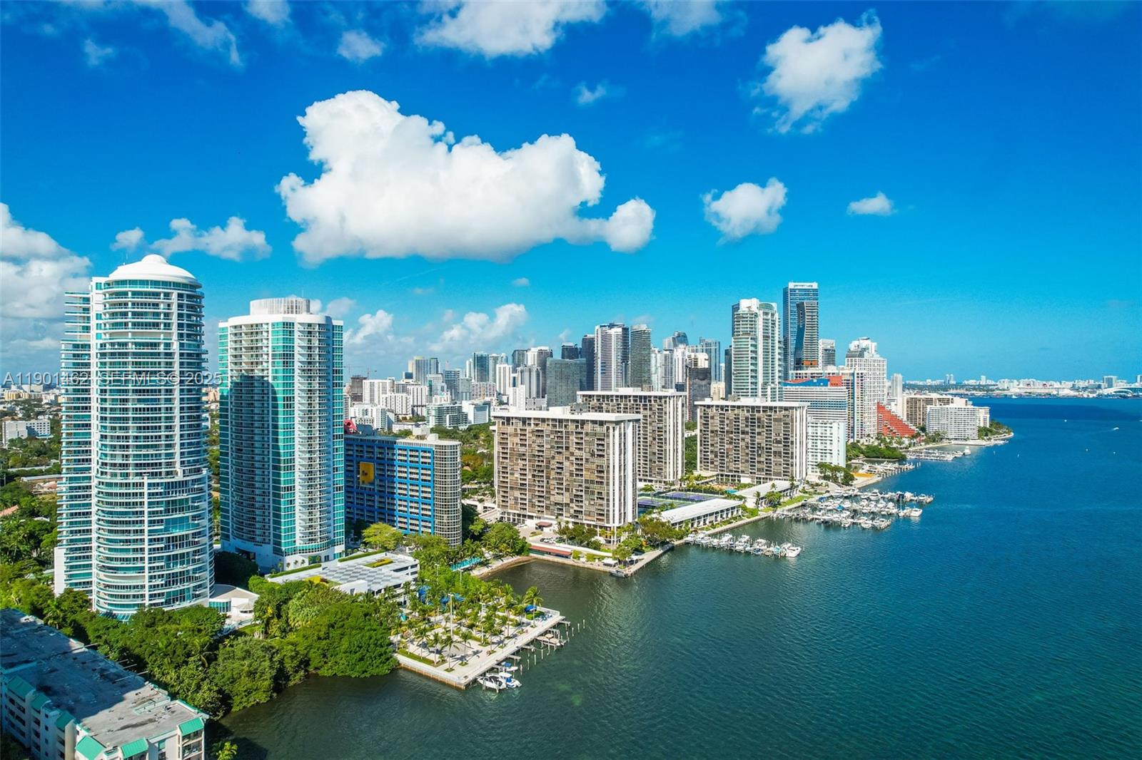 2101 Brickell Avenue, Unit 306 Miami, FL 33129 - Photo 44 of 49 a view of a balcony with dining table and chairs with wooden floor