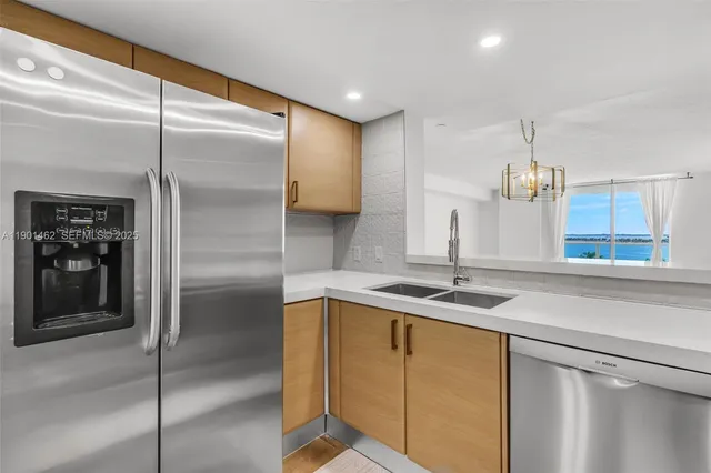 a kitchen with a sink and refrigerator