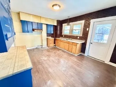 a large kitchen with a stove and large window