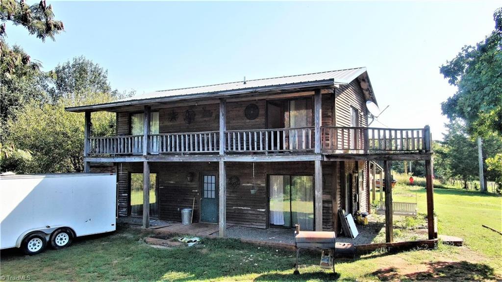 3834 Flynt Road Liberty, NC 27298 - Photo 1 of 40 Front of Farm home with wrap around porch.