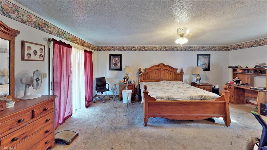 3834 Flynt Road Liberty, NC 27298 - Photo 11 of 40 Large master bedroom with 2 closets & one sliding door to balcony