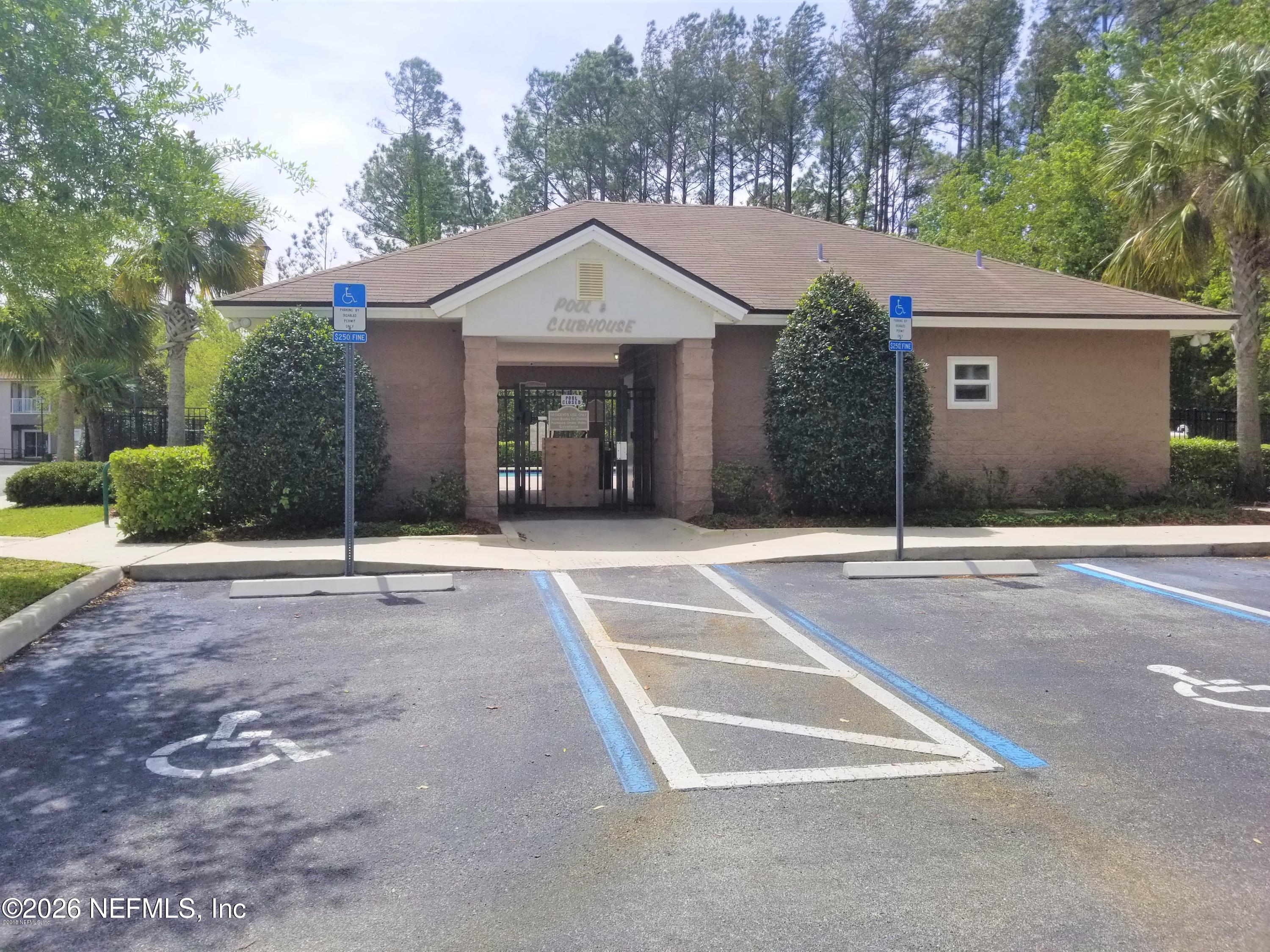 7920 Merrill Road, Unit 2004 Jacksonville, FL 32277 - Photo 10 of 13 a front view of a house with a yard and garage