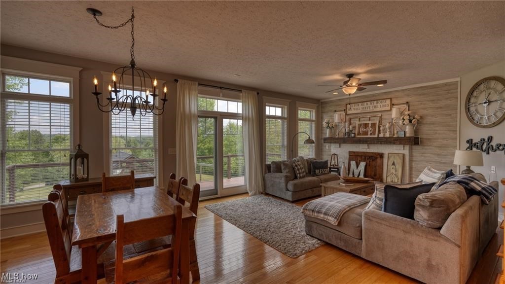 66333 Read Road Cambridge, OH 43725 - Photo 25 of 49 Living room featuring hardwood / wood-style flooring, ceiling fan with notable chandelier, and a textured ceiling