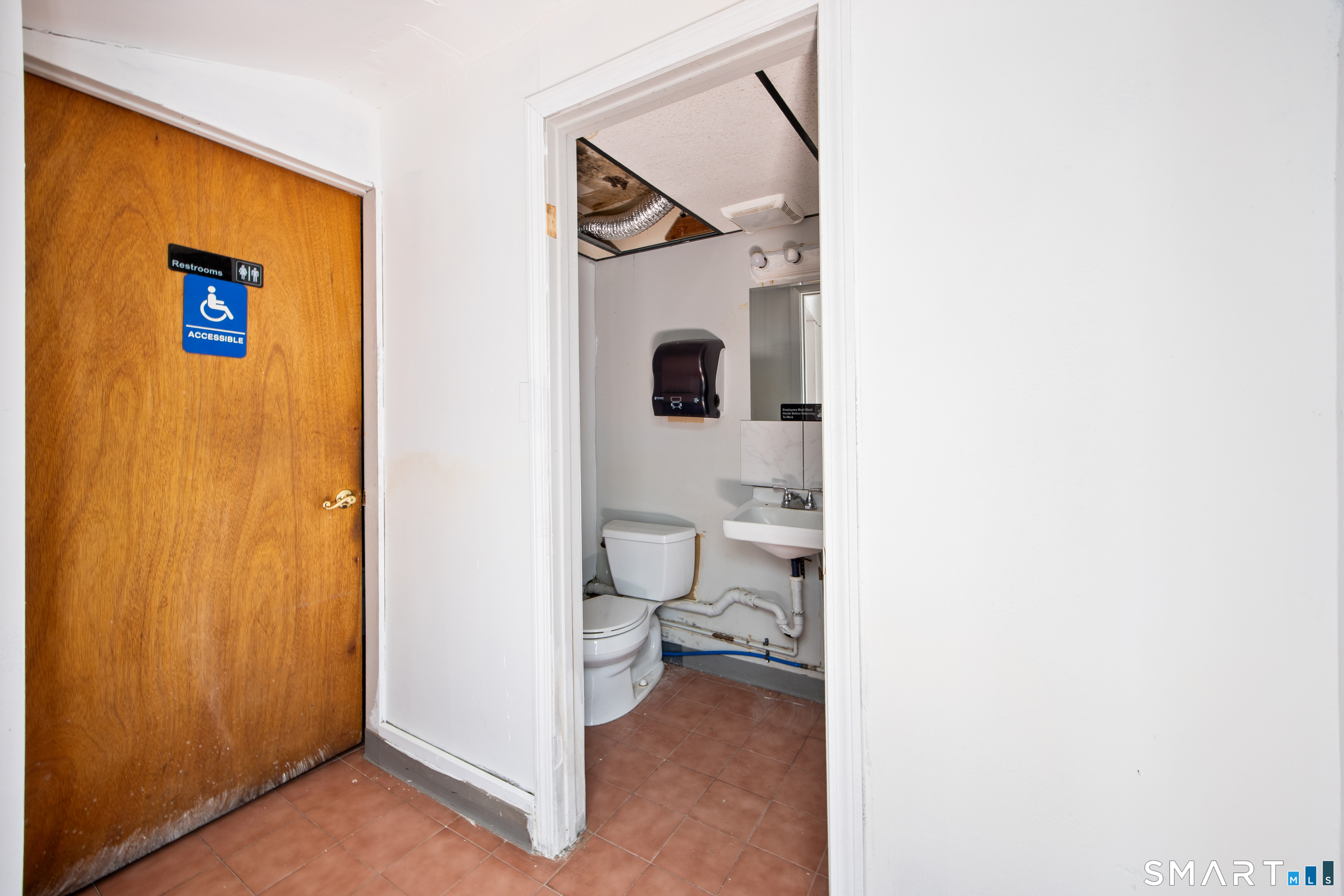 277 South Main Street Torrington, CT 06790 - Photo 13 of 26 a bathroom with a toilet and a painting on the wall