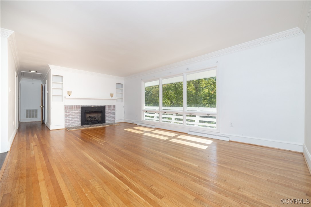 811 Forestview Drive Colonial Heights, VA 23834 - Photo 12 of 45 a view of an empty room with wooden floor and a window