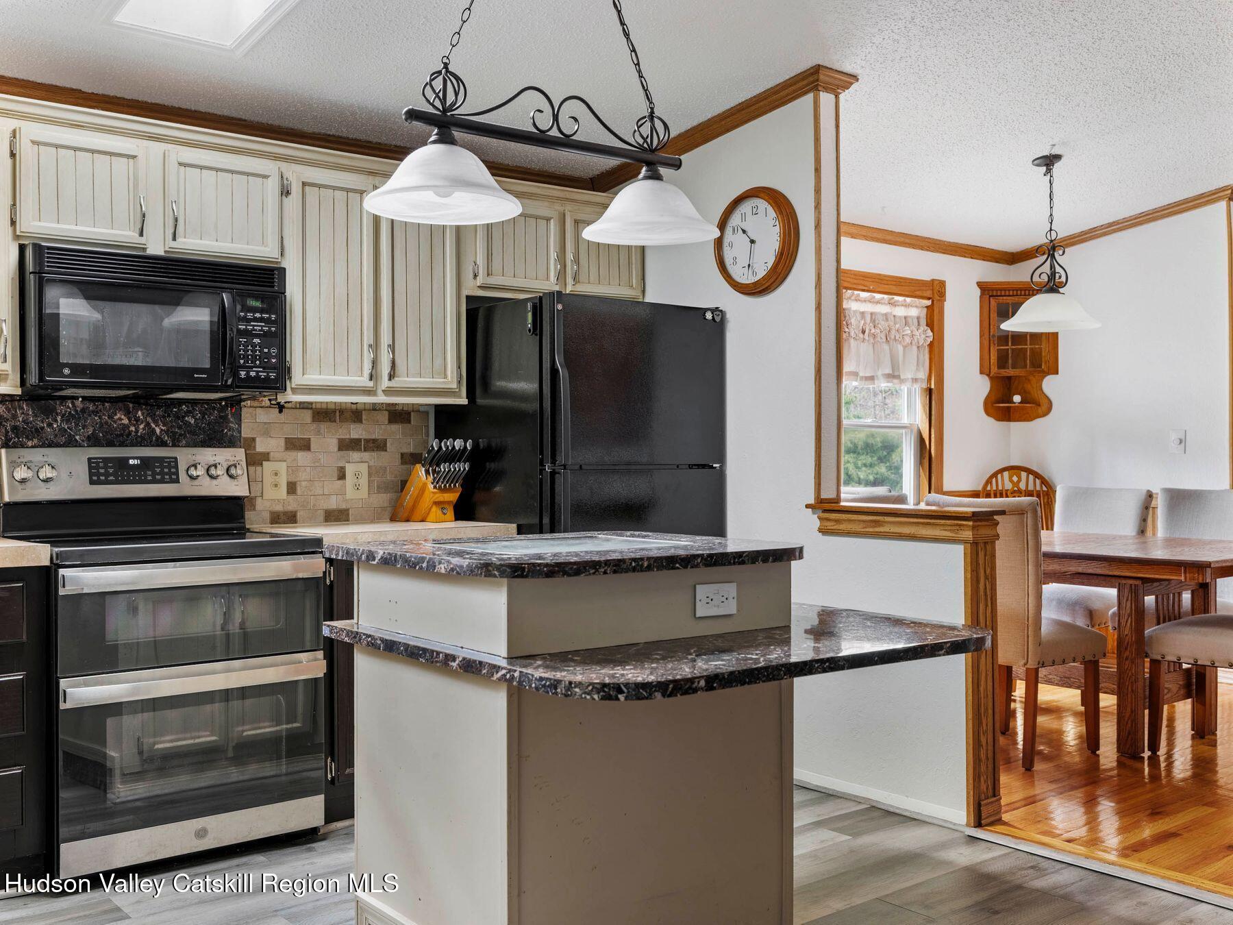 382 Cairo Junction Road Catskill, NY 12414 - Photo 9 of 38 a kitchen with stainless steel appliances granite countertop a stove and a microwave
