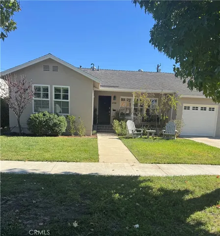 a front view of a house with a yard and porch