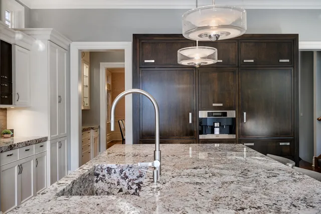 a bathroom with a granite countertop sink a toilet a mirror and shower