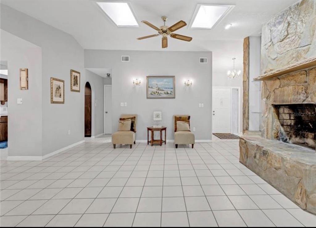4308 Allen Road Fruitland Park, FL 34731 - Photo 8 of 33 a living room with furniture and a fireplace