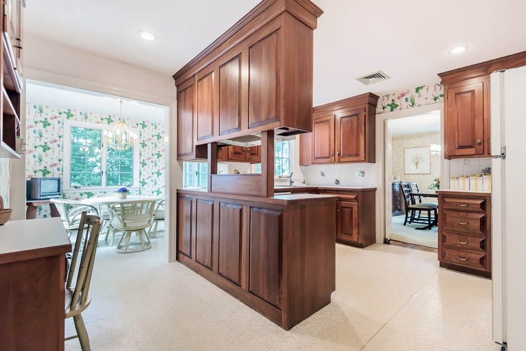 79 Cheever Circle Andover, MA 01810 - Photo 14 of 30 a kitchen with kitchen island granite countertop a stove top oven a sink a dining table and chairs