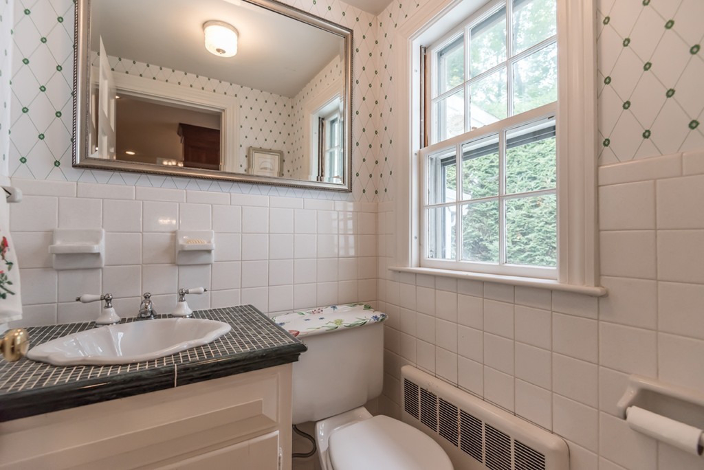79 Cheever Circle Andover, MA 01810 - Photo 19 of 30 a bathroom with a granite countertop sink a mirror and a toilet