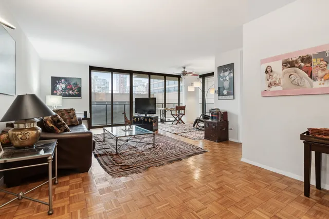 a living room with furniture a large window and a flat screen tv