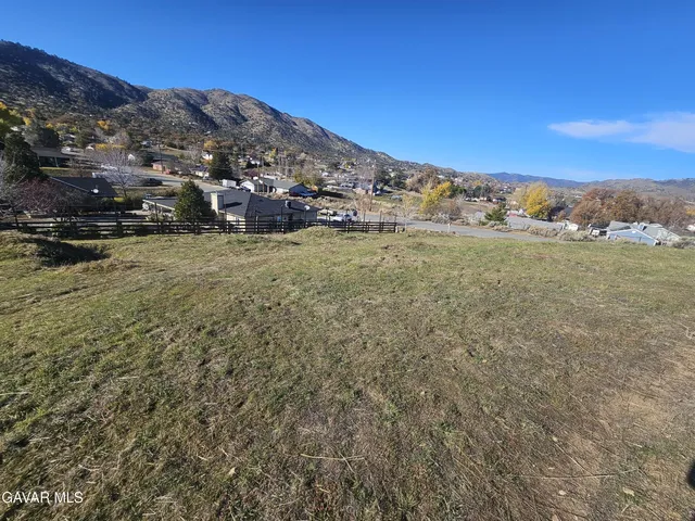 a view of a large building with mountains in the background