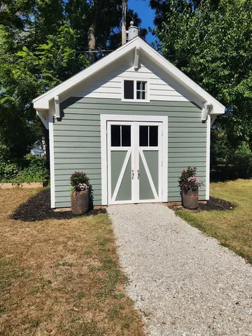 a front view of a house with a garden