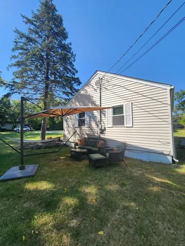 a front view of house with yard and trees