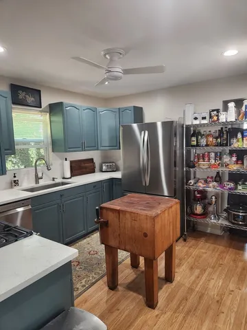 a bedroom with a bed and a refrigerator