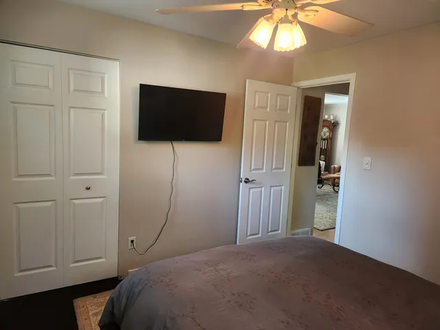 a bedroom with a bed and a flat screen tv