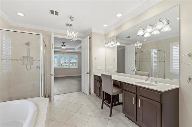 a bathroom with a sink mirror and a shower