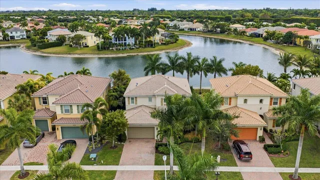 an aerial view of house with yard and lake view