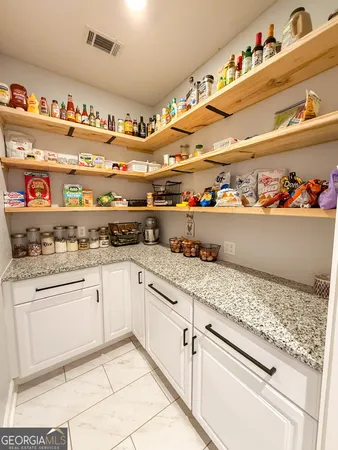 a spacious bedroom with a bed and a large cabinets