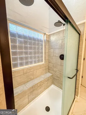 a bathroom with a toilet and a shower curtain