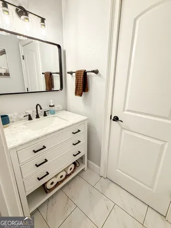 a kitchen with stainless steel appliances granite countertop a refrigerator sink and white cabinets
