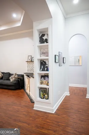 a kitchen with granite countertop a sink stainless steel appliances and white cabinets