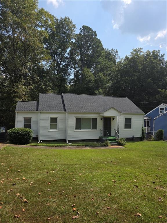 a front view of house with yard and green space