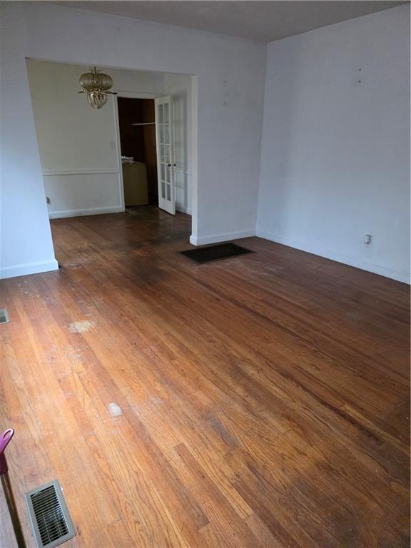1438 Wichita Drive Southwest Atlanta, GA 30311 - Photo 2 of 5 a view of an empty room with wooden floor and closet