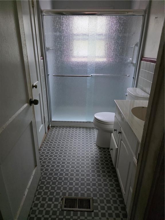 1438 Wichita Drive Southwest Atlanta, GA 30311 - Photo 3 of 5 a bathroom with a sink a toilet a window and shower