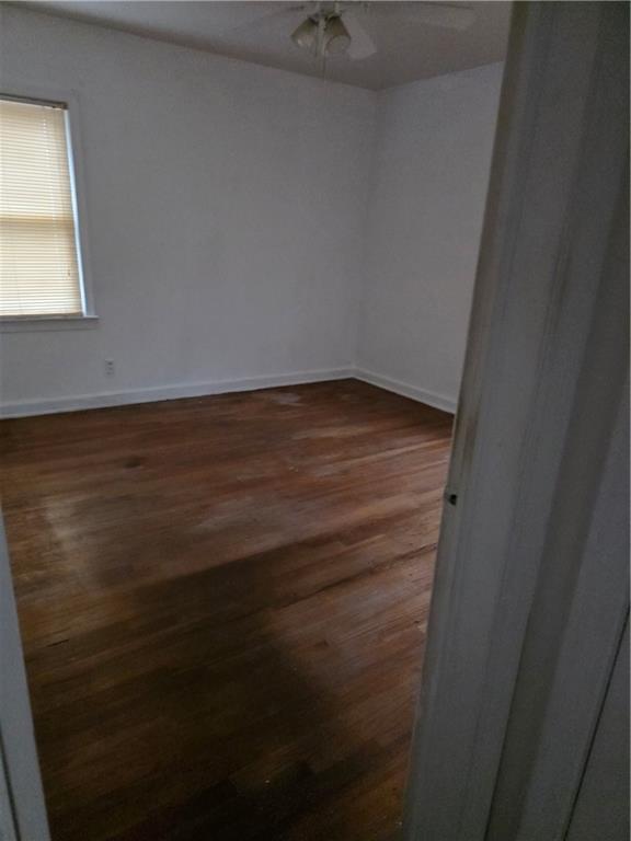 1438 Wichita Drive Southwest Atlanta, GA 30311 - Photo 4 of 5 a view of an empty room with wooden floor and a window