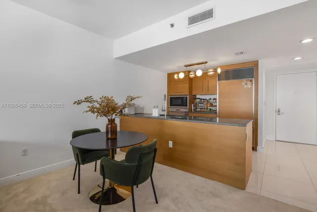 a view of living room with kitchen island furniture and large window