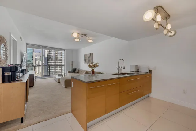 a bedroom with a bed and a lamp next to a window