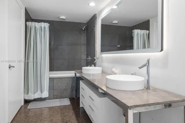 a bedroom with a bed and a night stand