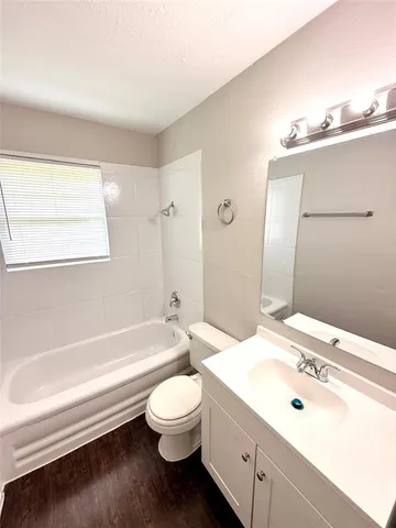 a bathroom with a sink a toilet and bathtub